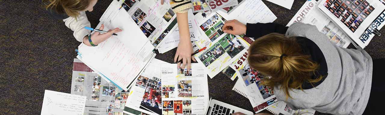 Students Working on High School Yearbook Designs with Jostens