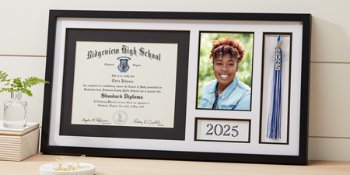 Grad holding Jostens class graduation keepsakes