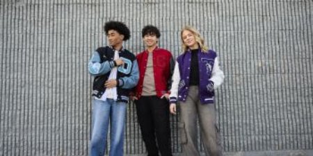 Students posing in their letterman jackets.