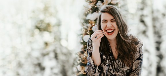 Girl interviewed smiling with a candy cane